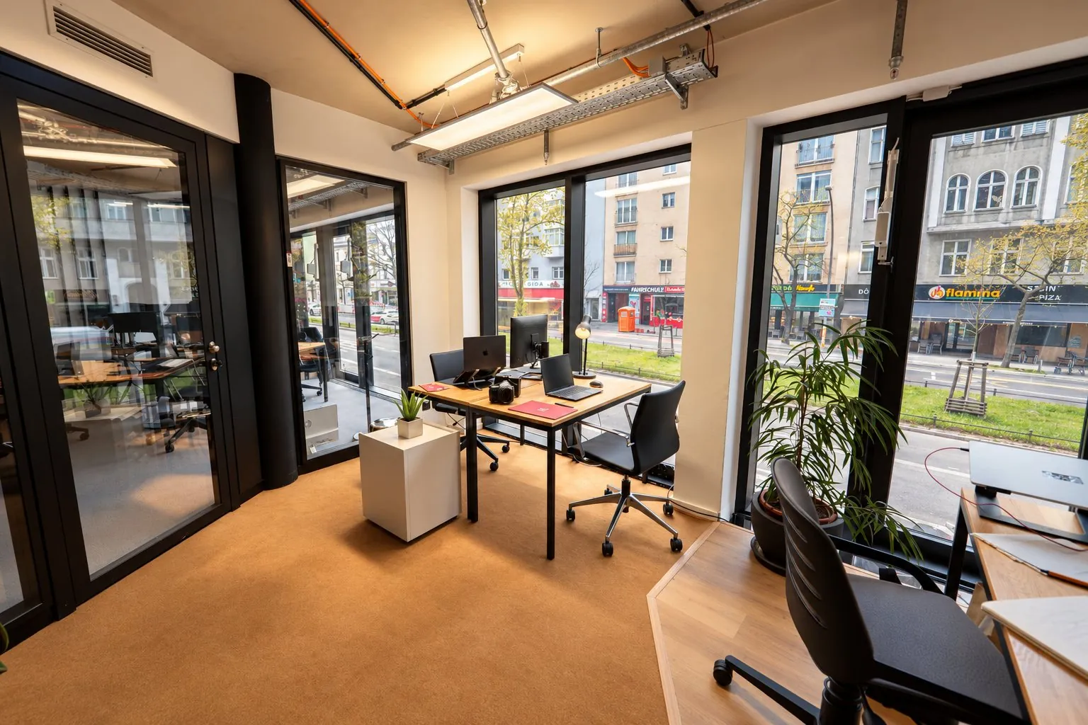 A workspace in the Digimark office with a camera on the desk and a view of the street